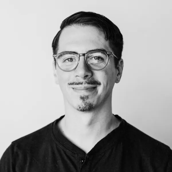 My headshot: a white man with short hair, glasses, and a friendly smile.